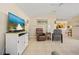 Inviting living room with tile flooring and a television with comfortable seating at 3614 January Ave, North Port, FL 34288