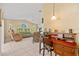 Comfortable living room with a desk, tile flooring, and a ceiling fan at 3614 January Ave, North Port, FL 34288