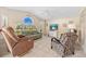 Bright living room with tile flooring, lots of seating and a ceiling fan at 3614 January Ave, North Port, FL 34288