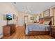 Large bedroom with a ceiling fan, wood flooring and slider to the lanai at 3614 January Ave, North Port, FL 34288