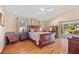 Spacious bedroom with wood floors, ceiling fan, and slider to the patio at 3614 January Ave, North Port, FL 34288