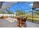 Screened patio with comfortable seating offers picturesque backyard views at 3614 January Ave, North Port, FL 34288