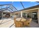 Screened patio featuring a stone floor and outdoor furniture with picturesque backyard views at 3614 January Ave, North Port, FL 34288