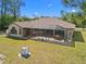 An aerial view of the home showcasing a large screened lanai with a brown roof under a clear blue sky at 3614 January Ave, North Port, FL 34288