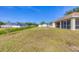 View of the property's backyard including a covered patio and adjacent residences at 3935 Nemo Ave, North Port, FL 34287