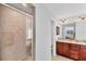Bathroom showcasing the glass-enclosed shower and double sink vanity with wood cabinets at 3935 Nemo Ave, North Port, FL 34287