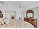 Bright primary bedroom with a large bed, ceiling fan, and en-suite bath access at 3935 Nemo Ave, North Port, FL 34287