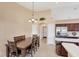 Dining area with table and seating next to stainless steel fridge and kitchen at 3935 Nemo Ave, North Port, FL 34287