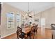 Elegant dining room with hardwood floors, shuttered windows and a decorative chandelier at 3935 Nemo Ave, North Port, FL 34287