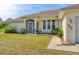 Charming single-story home featuring a screened front entry and a well-manicured lawn at 3935 Nemo Ave, North Port, FL 34287
