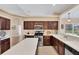 Bright kitchen featuring stainless steel appliances, wood cabinets, and white countertops at 3935 Nemo Ave, North Port, FL 34287