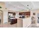 Spacious kitchen with stainless steel appliances, wood cabinets, and a breakfast bar at 3935 Nemo Ave, North Port, FL 34287
