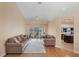 Open-concept living room with hardwood floors, neutral walls, and sliding glass doors to the lanai at 3935 Nemo Ave, North Port, FL 34287