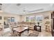 Spacious living room with a large leather sofa, ceiling fan, and sliding glass doors at 3935 Nemo Ave, North Port, FL 34287
