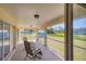 Enclosed patio provides an outdoor living space with seating and views of the backyard at 3935 Nemo Ave, North Port, FL 34287