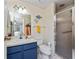Cozy bathroom features a blue vanity and a glass-enclosed shower for a functional space at 4022 Beaver Ln # 500C, Port Charlotte, FL 33952