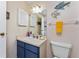 Bathroom features a blue vanity and decorative fish art for a touch of whimsy at 4022 Beaver Ln # 500C, Port Charlotte, FL 33952