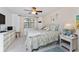 Cozy bedroom featuring tile floors, ceiling fan, coastal decorations, and a well-lit window at 4022 Beaver Ln # 500C, Port Charlotte, FL 33952