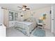 Bright bedroom featuring tile floors, ceiling fan, and decorative coastal themed accents at 4022 Beaver Ln # 500C, Port Charlotte, FL 33952