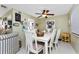 Cozy dining area featuring a white table, ceiling fan, and decorative wall art at 4022 Beaver Ln # 500C, Port Charlotte, FL 33952