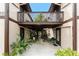 Charming condo entrance featuring a lovely courtyard and stairs to the upper level at 4022 Beaver Ln # 500C, Port Charlotte, FL 33952