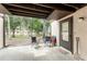 Covered ground floor patio with seating area, overlooking the scenic, tree-filled grounds at 4022 Beaver Ln # 500C, Port Charlotte, FL 33952