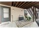 Covered ground floor entry of condo, showing stairs to upper floor and small garden area at 4022 Beaver Ln # 500C, Port Charlotte, FL 33952