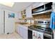 Bright kitchen featuring stainless steel oven, light countertops, and modern fixtures at 4022 Beaver Ln # 500C, Port Charlotte, FL 33952