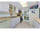 Spacious kitchen featuring white appliances, light countertops, and view to dining area at 4022 Beaver Ln # 500C, Port Charlotte, FL 33952