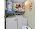 Functional laundry area with washer, dryer, and storage solutions for efficient home management at 4022 Beaver Ln # 500C, Port Charlotte, FL 33952