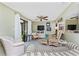 Comfortable living room featuring wicker furniture, tile flooring, and a ceiling fan at 4022 Beaver Ln # 500C, Port Charlotte, FL 33952