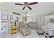 Cozy living room featuring comfortable seating, ceiling fan, and an open view to the kitchen at 4022 Beaver Ln # 500C, Port Charlotte, FL 33952