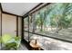 Cozy screened patio provides a peaceful retreat with views of lush greenery and mature trees at 4022 Beaver Ln # 500C, Port Charlotte, FL 33952