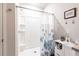 White bathroom features a shower with a sliding glass door and white vanity with granite countertops at 5309 Shell Mound Cir, Punta Gorda, FL 33982