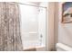 White bathroom features a tub and shower combination with a shower curtain and a toilet at 5309 Shell Mound Cir, Punta Gorda, FL 33982