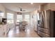 Bright breakfast area features a round table, stainless steel refrigerator and natural light from windows at 5309 Shell Mound Cir, Punta Gorda, FL 33982