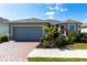 Charming single-story home featuring a brick driveway, two-car garage and beautifully landscaped front yard at 5309 Shell Mound Cir, Punta Gorda, FL 33982
