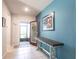 Bright foyer with tile flooring, blue accent wall, table and view of screen enclosed porch at 5309 Shell Mound Cir, Punta Gorda, FL 33982