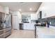 Well-lit kitchen with stainless steel appliances, white cabinets and tile flooring at 5309 Shell Mound Cir, Punta Gorda, FL 33982