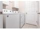 Modern laundry room with new washer and dryer units and white cabinets at 5309 Shell Mound Cir, Punta Gorda, FL 33982