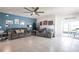 Open living room features tile floors, ceiling fan, comfortable seating, and sliding glass doors to lanai at 5309 Shell Mound Cir, Punta Gorda, FL 33982