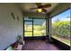 Cozy sunroom features a brick floor, ceiling fan, and access to the backyard at 5309 Shell Mound Cir, Punta Gorda, FL 33982