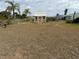 The fenced backyard has a shed plus mature landscaping and a couple of palm trees at 6249 Drucker Cir, Port Charlotte, FL 33981