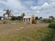 Backyard view with a shed surrounded by a chain-link fence, plus a palm tree at 6249 Drucker Cir, Port Charlotte, FL 33981