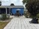 Spacious backyard with a patio dining set under an umbrella, mature foliage, and an outdoor grill at 6249 Drucker Cir, Port Charlotte, FL 33981
