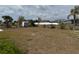 Backyard view with a shed featuring a chain link fence and small palm trees at 6249 Drucker Cir, Port Charlotte, FL 33981