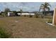 The chain-link fenced backyard has a shed, small shrubs, and an immature palm tree at 6249 Drucker Cir, Port Charlotte, FL 33981