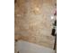 Bathroom featuring shower with tan marble tile and built-in shelving at 6249 Drucker Cir, Port Charlotte, FL 33981