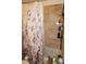 Bathroom featuring a shower with marble tile and decorative floral curtain at 6249 Drucker Cir, Port Charlotte, FL 33981