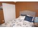 Bedroom featuring queen-sized bed and closet with brown walls and tile flooring at 6249 Drucker Cir, Port Charlotte, FL 33981
